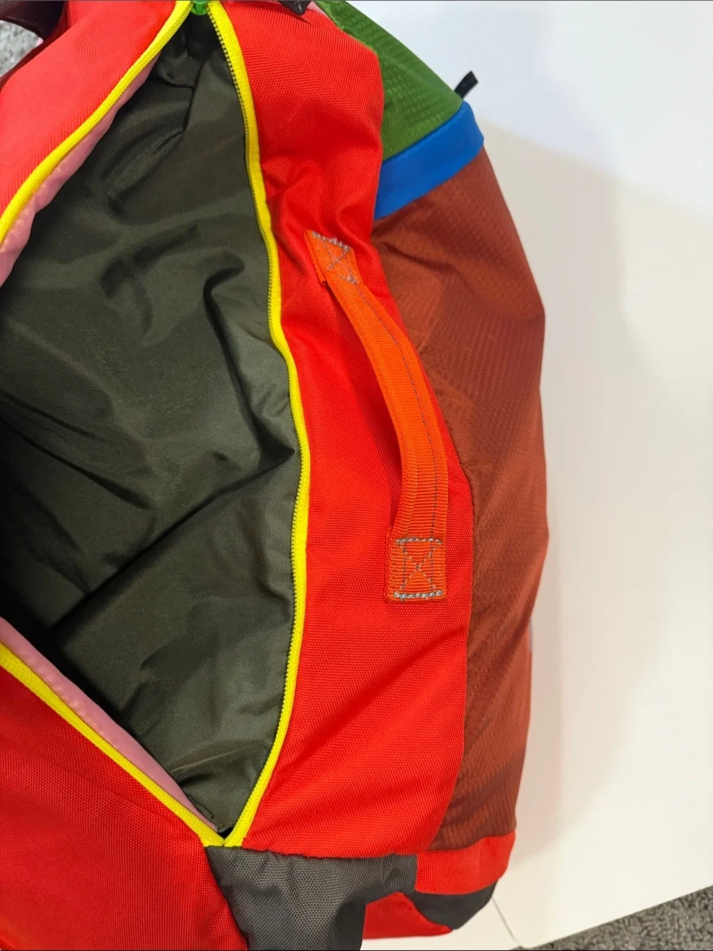 cotopaxi Green Duffel with Orange Logo and Multicolor Panels